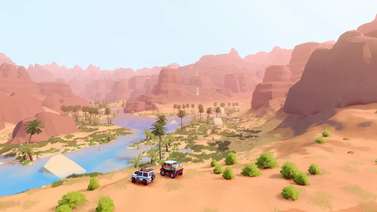 A convoy drives above a turquoise river in a sandy desert valley.